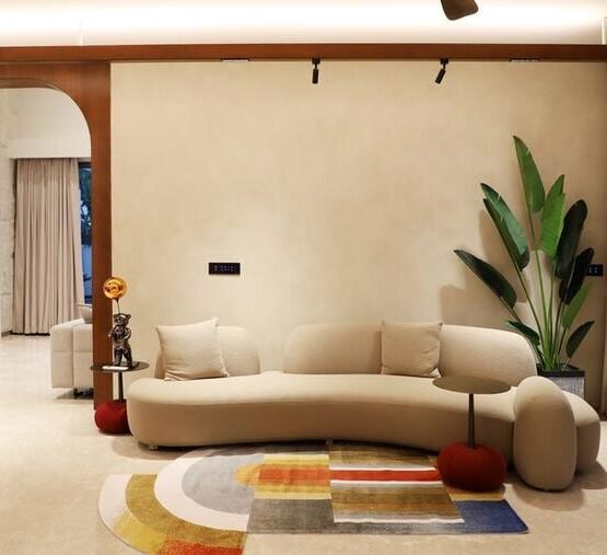Round multicolour accent rug in a warm modern living room.