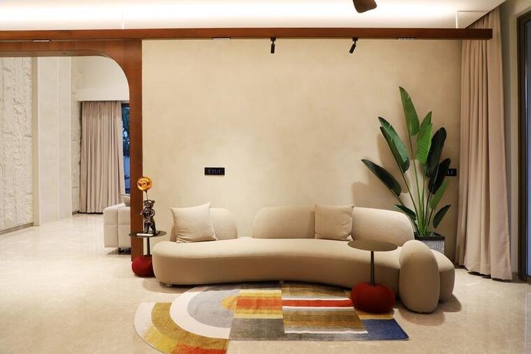 Round multicolour accent rug in a warm modern living room.