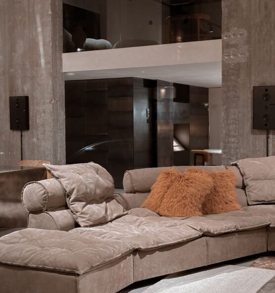 Plush beige sectional sofa with cushions in a contemporary room.