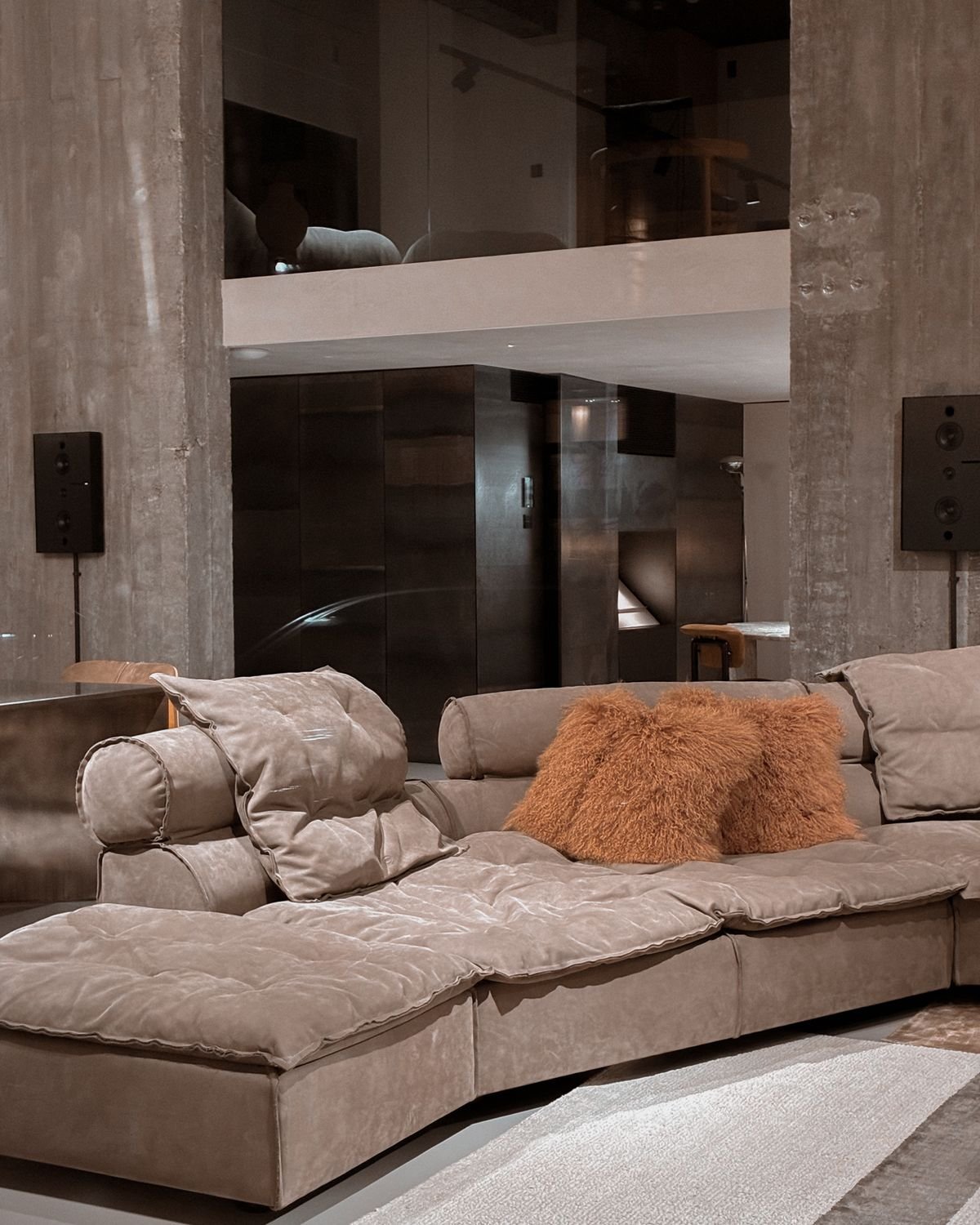 Plush beige sectional sofa with cushions in a contemporary room.