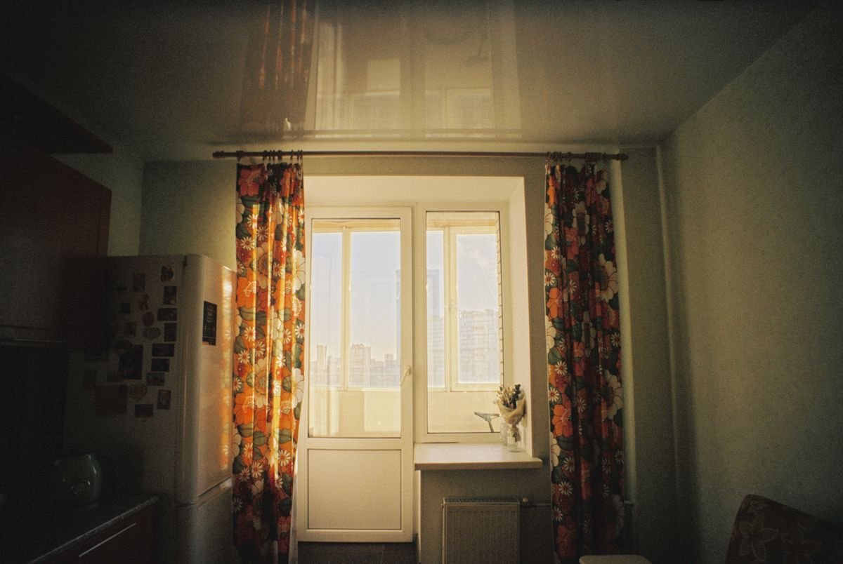Floral patterned curtains framing a bright window.