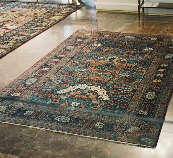 Ornate deep-toned rug with a central medallion on a polished floor.