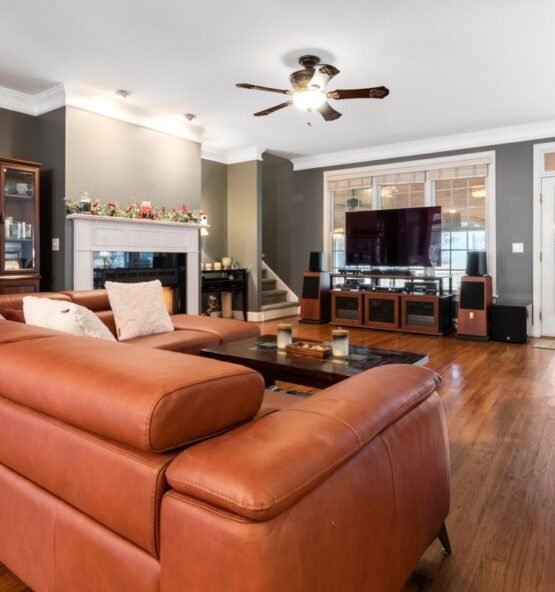 Cognac leather sofa in a furnished living room.