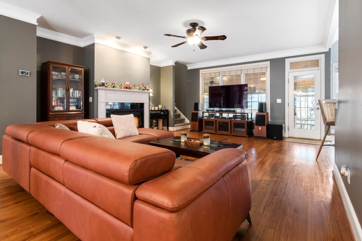 Cognac leather sofa in a furnished living room.