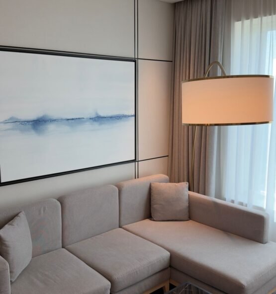 Compact neutral corner sofa in a minimalist living room.