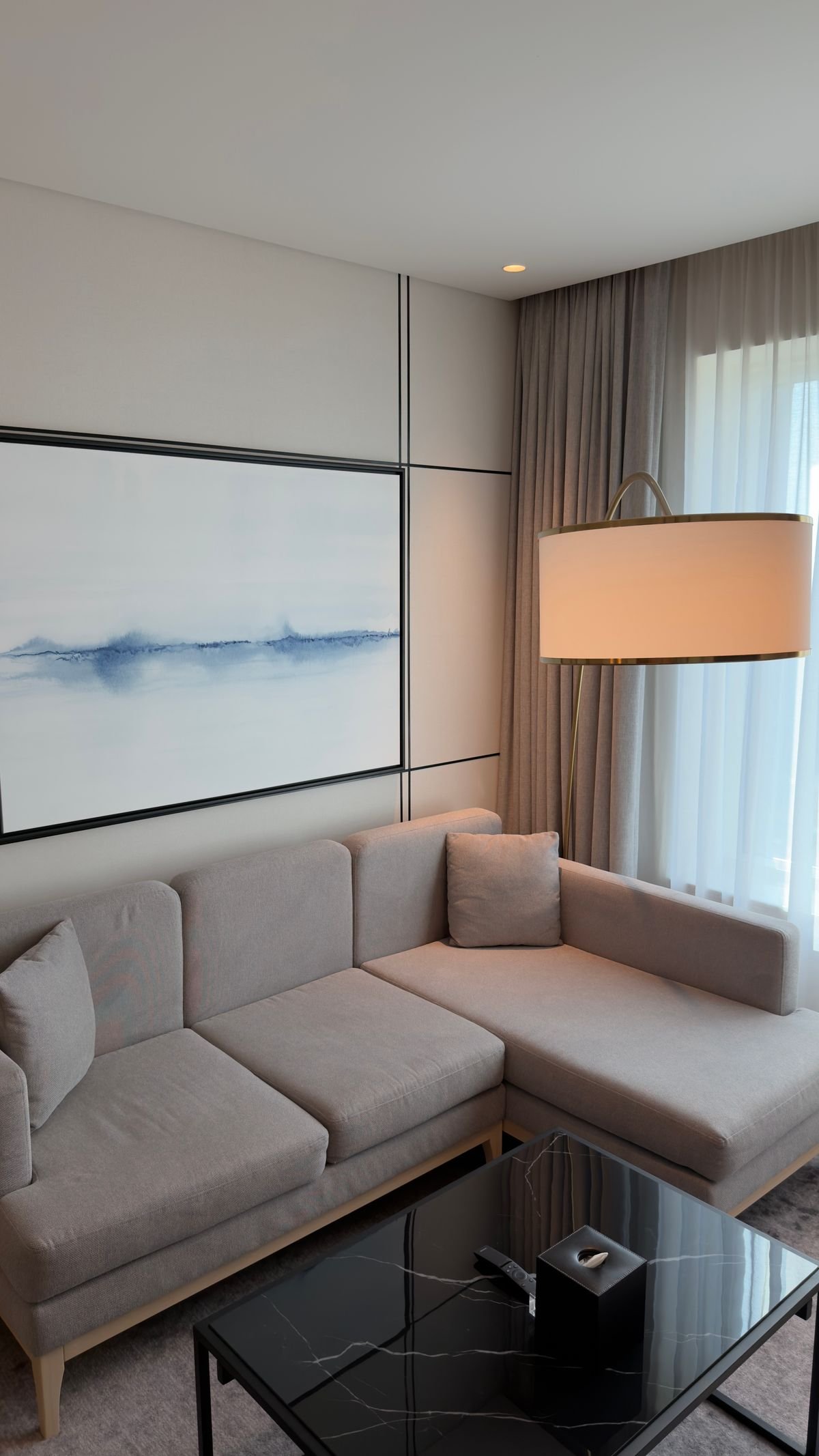 Compact neutral corner sofa in a minimalist living room.