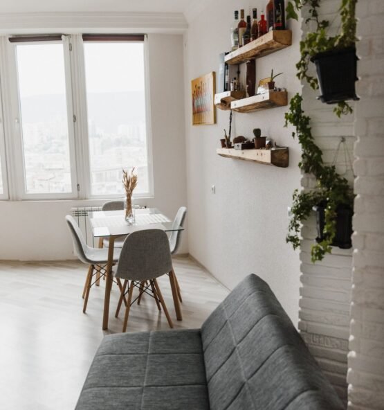 Compact gray sofa in a bright apartment living space.