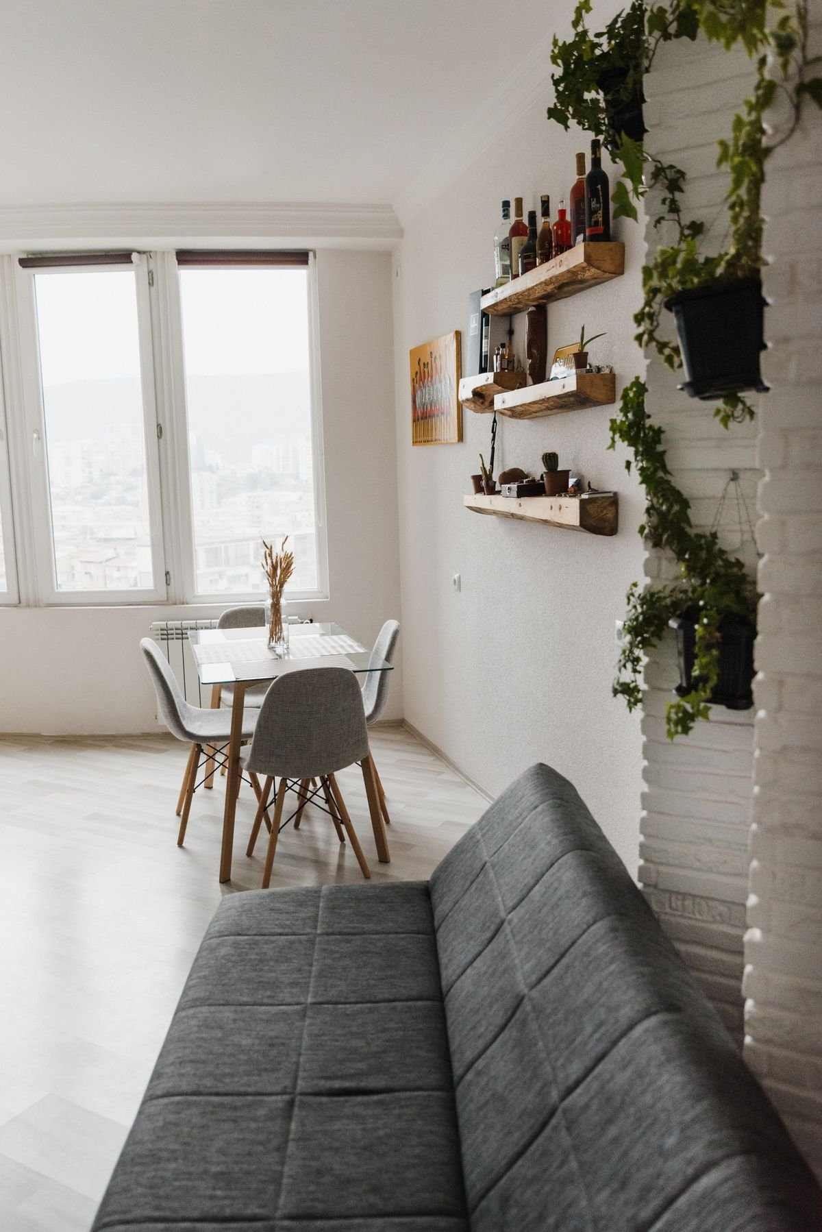 Compact gray sofa in a bright apartment living space.